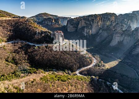 Veduta aerea del monastero Rousanou e della pittoresca valle mozzafiato e punto di riferimento canyon di Meteora al tramonto, Kalambaka, Grecia, ombre, torsione ro Foto Stock