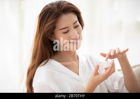 Giovane donna cinese con aloe vera naturale a casa Foto Stock