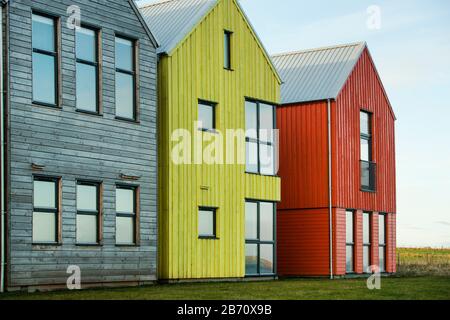 Il John o'Groats Hotel, ora la locanda a John o'Groats, con edifici in legno multicolore in stile nordico scandi a John o'Groats, Caithness, Scozia Foto Stock