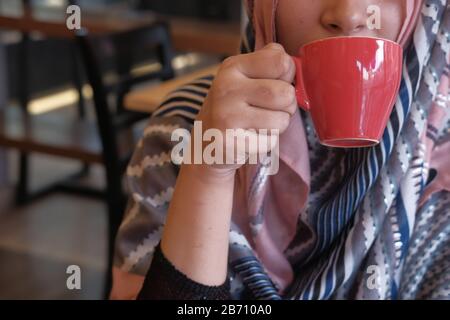 Primo piano delle giovani donne musulmane che bevono caffè Foto Stock