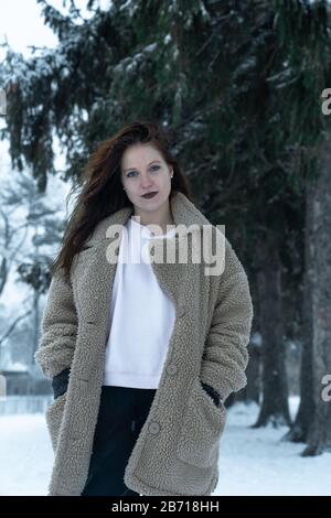 Canadian Winter Snowy Portraiture Foto, bella giovane Brunette modello divertirsi nella neve fresca Foto Stock