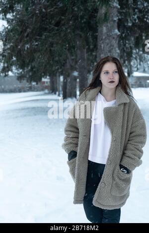 Canadian Winter Snowy Portraiture Foto, bella giovane Brunette modello divertirsi nella neve fresca Foto Stock