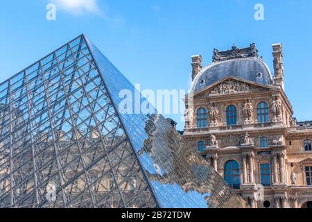 Francia. Giornata di sole a Parigi. L'edificio del Louvre si riflette sulle facce della piramide di vetro Foto Stock