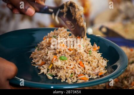 Jellof Camerunese di riso jollof sul tavolo a buffet ad una festa per pranzo. Contiene riso e una miriade di verdure. Foto Stock