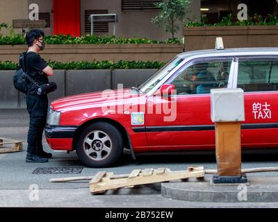 Un protesta blocca il traffico nel quartiere centrale durante una parata. I manifestanti si scontrano violentemente con la polizia anti-sommossa di Hong Kong durante il 70° anniversario della Cina. Foto Stock