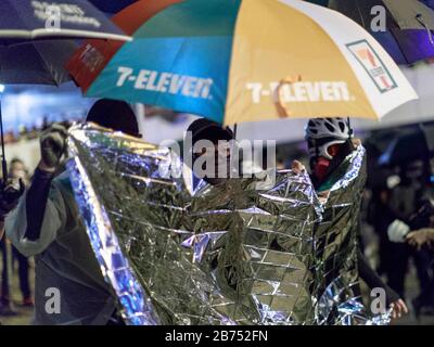 I manifestanti si confrontano con la polizia nel quinto anniversario del movimento ombrello in Ammiragliato. La polizia usa il cannone d'acqua per disperderli. Foto Stock