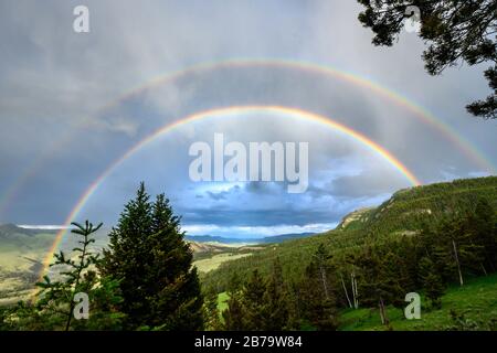 Blue Sky Glow attraverso un doppio arcobaleno sulla natura selvaggia di Yellowstone Foto Stock