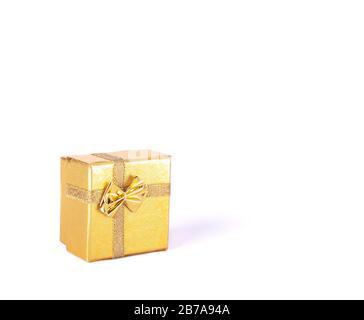 Confezione regalo di colore oro con striscia e arco su fondo bianco isolato Foto Stock