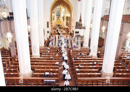 Lipsia, Germania. 15 Mar 2020. Solo pochi visitatori seguono il percorso dei cantanti del coro per ragazzi Unser Lieben Frauen Bremen in quello che è probabilmente l'ultimo servizio della domenica nella chiesa di San Tommaso. La parrocchia ha reagito alla diffusione del virus corona e di un ordine urbano per i limiti di visitatori di meno di 200 persone e ha lasciato solo 100 visitatori nella chiesa. Il coro dei ragazzi, che doveva avere due mottetti il venerdì e il sabato e il servizio la domenica, aveva già iniziato il suo viaggio prima dell'emissione dell'ordine. Credit: Waltraud Gruchitzsch/Zentralbild/Dpa/Alamy Live News Foto Stock