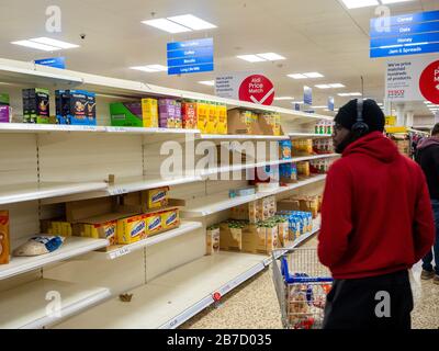 Scaffali vuoti presso un negozio Tesco Extra a nord di Londra. Foto Stock