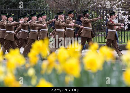 Le Guardie Irlandesi marciano lungo la Birdcage Walk durante la sfilata del giorno di San Patrizio, sulla loro strada per il Guards Memorial a St James's Park, Londra. Foto Stock