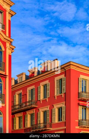 Vista al tramonto delle tradizionali case mediterranee in Place Massena, punto di riferimento commerciale e culturale nella città vecchia Vielle Ville di Nizza, Francia meridionale Foto Stock