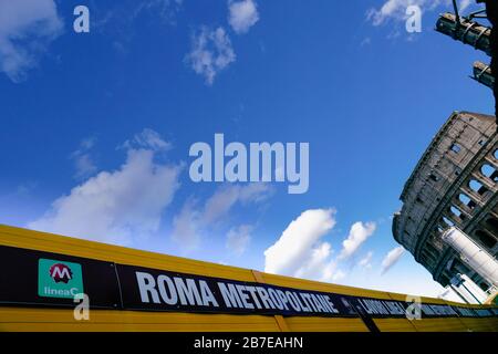 Cantiere per la nuova linea metropolitana C, metropolitana, metropolitana. Segnaletica in primo piano, Colosseo sullo sfondo. Centro storico di Roma. Italia. Foto Stock