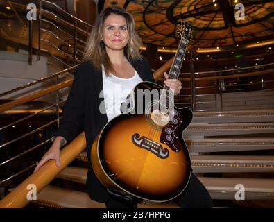 Angela Grace Brown, cantante e chitarrista, posa nell'atrio a bordo di Oceana Foto Stock