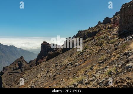 Sopra le nuvole. Vista aerea del Parco Nazionale Caldera de Taburiente, cratere vulcanico visto dalla cima di montagna del punto panoramico Roque de los Muchachos. Foto Stock