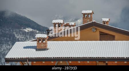 tetto innevato con camino Foto Stock