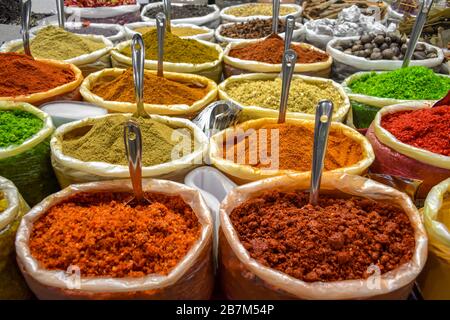 Spezie colorate di molte varietà accatastate in vendita nel tradizionale mercato all'aperto dell'India. Queste spezie sono usate come condimenti, per aromatizzare il cibo. Foto Stock