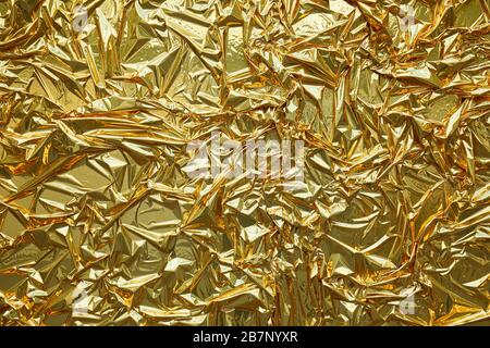 Sfondo con texture in lamina metallizzata dorata Foto Stock