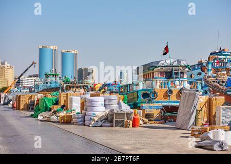 Dubai, Emirati Arabi Uniti - 31 gennaio 2020: Barche tradizionali in dhow arabo e merci diverse preparate per il trasporto sul molo di Deira a Dubai, Emirati Arabi Uniti Foto Stock