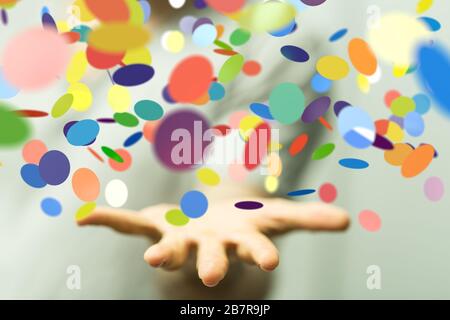 Primo piano di una persona che presenta la proiezione virtuale di confetti colorati Foto Stock