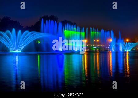 Notte d'estate. Fontana a colori e spettacolo laser Foto Stock