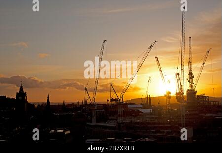 Edimburgo, Scozia, Regno Unito. 18th Mar 2020. Tramonto colorato sul centro della città. Architettura storica della torre dell'orologio del Balmoral Hotel e del sito di costruzione industriale che è Edinburgh St James Centre. Foto Stock