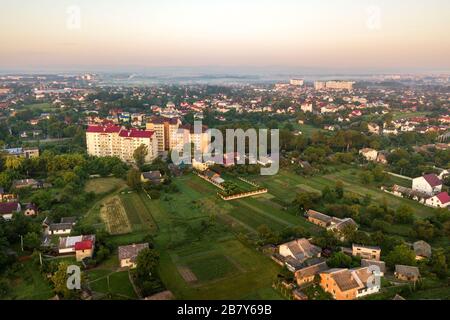 Paesaggio di antenna di piccole città o villaggio con file di case residenziali e il verde degli alberi. Foto Stock