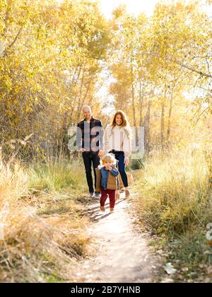 Famiglia a piedi sulla foresta percorso Foto Stock