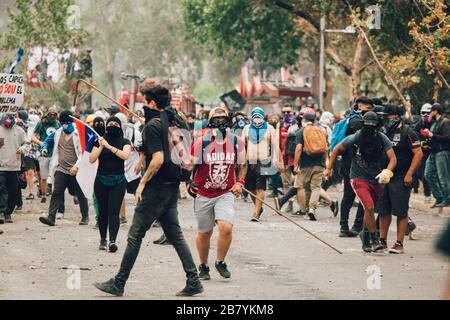 SANTIAGO, CILE-8 NOVEMBRE 2019 - i manifestanti si trovano di fronte alla polizia antisommossa durante le proteste contro il governo di Pinera, per la crisi sociale del paese Foto Stock
