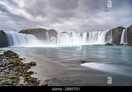 Cascata Godafoss, nebbia da spruzzi d'acqua in una mattina nuvolosa, Islanda Foto Stock