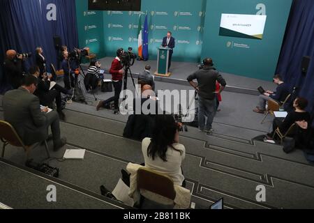 I giornalisti osservano le distanze sociali mentre il Ministro dell'Istruzione Joe McHugh parla ai media ad un briefing sul coronavirus (Covid-19) presso gli edifici governativi di Dublino. Foto Stock