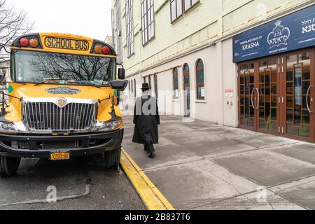 New York, NY - 19 marzo 2020: L'uomo ebraico hassidico passa yeshiva privata (scuola) nell'area di Borough Park di Brooklyn, dove sono stati registrati molti casi positivi Foto Stock