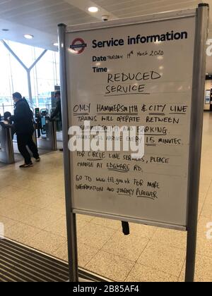 Un cartello che informa i passeggeri di un servizio ridotto sulla metropolitana alla stazione di Paddington di Londra. Foto Stock