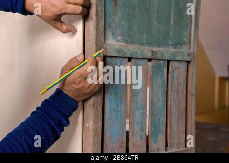 Carpenter lavorando su macchine per la lavorazione del legno in falegnameria shop. Un uomo che lavora in un negozio di falegnameria. Foto Stock