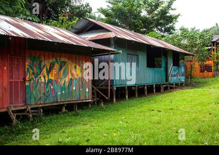 Dipinti esotici sulle case indiane della tribù Ticuna comunità, Mocagua, Amazon Rain Forest, Colombia, Sud America. Foto Stock