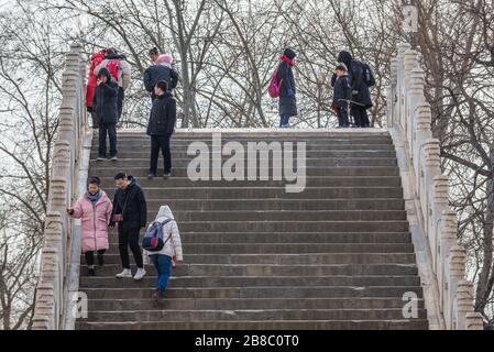 Turisti sul ponte della cintura di giada su un lago Kunming nel Palazzo d'Estate, ex giardino imperiale a Pechino, Cina Foto Stock