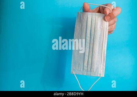 Una maschera sanitaria aiuta a prevenire l'ingresso del virus Corona o di altre malattie. L'antisettico alcolico pulisce le mani e il viso dall'infezione. Spazio di copia Foto Stock