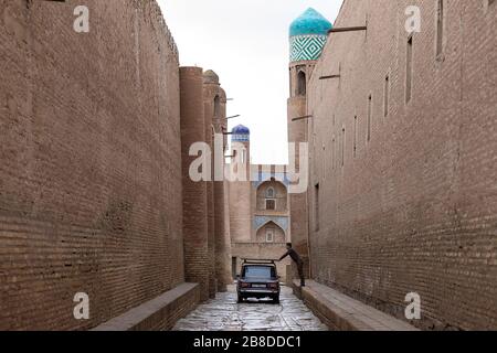 Auto in una strada stretta a Khiva, Uzbekistan Foto Stock