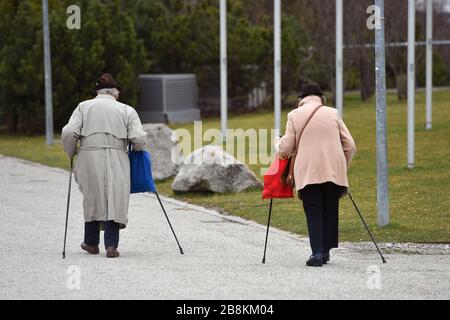 Nessuna riunione di più di due federazioni di persone e paesi presumibilmente vogliono decidere di non contattare. Archivio foto: Pensionato uomo e moglie, a piedi con bastoni su un sentiero lastricato. Vecchio, povertà in vecchiaia. | utilizzo in tutto il mondo Foto Stock