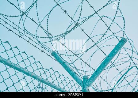 Recinzione di bordo con filo spinato. Chiusura per quarantena. Struttura di massima sicurezza. Foto Stock