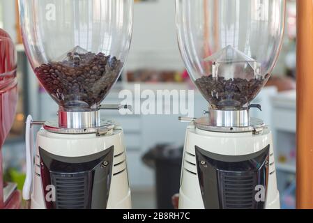 Macinacaffè che si prepara a macinare il caffè nel caffè. Foto Stock