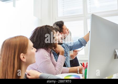 I Web designer e gli sviluppatori del team creativo di start-up sul computer hanno una visione Foto Stock