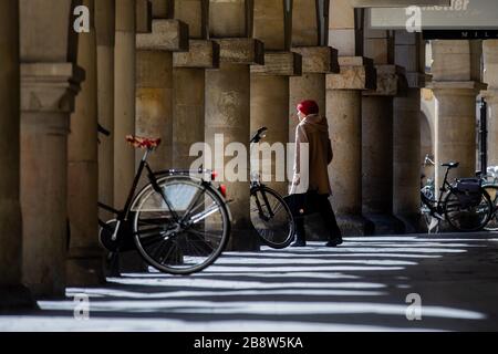 23 marzo 2020, Renania settentrionale-Vestfalia, Münster: Una donna attraversa il Prinzipalmarkt. Per rallentare la diffusione del coronavirus, il governo federale ha fortemente limitato la vita pubblica. Foto: Rolf Vennenbernd/dpa Foto Stock