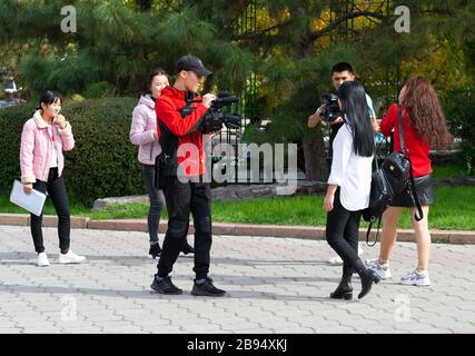 Gruppo di giovani studenti a Bishkek, Kirghizistan, che lavorano in un progetto cinematografico per la classe con due telecamere di registrazione. Adolescenti in Asia centrale. Foto Stock