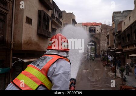 Peshawar, Pakistan. 23 marzo 2020. Un soccorritore disinfetta le strade di Peshawar nel tentativo di frenare la diffusione dell'epidemia di virus corona. La stragrande maggioranza della gente si recupera dal nuovo virus della corona. Secondo l'Organizzazione Mondiale della Sanità, la maggior parte delle persone si ritrovano in circa due o sei settimane, a seconda della gravità della malattia. Credit: SOPA Images Limited/Alamy Live News Foto Stock