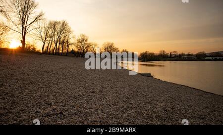 Persone sulla riva del lago jarun, godendosi il tramonto pochi giorni prima che il virus corona si blocchi a Zagabria e le riunioni sociali sono stati vietati Foto Stock