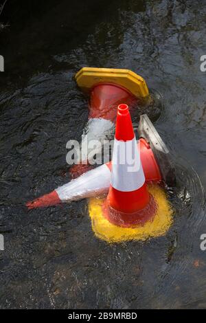 Coni di traffico che sono stati gettati da un ponte da lavori stradali nel River Stour a Gillingham North Dorset England GB Foto Stock