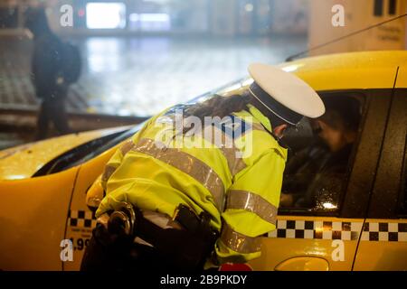 Bucarest, Romania - 23 marzo 2020: La polizia controlla i piloti e le loro carte durante il coprifuoco nelle strade di Bucarest in mezzo alla diffusione del CO Foto Stock