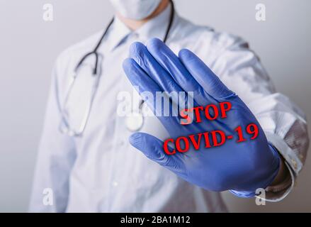 Medico che mostra un gesto di interruzione al coronavirus COVID-19. Foto Stock