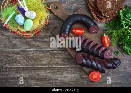 Morsilla - salsiccia di sangue. Pezzi di budino nero spagnolo su un tagliere di legno. Menu di Pasqua. La vista dall'alto Foto Stock